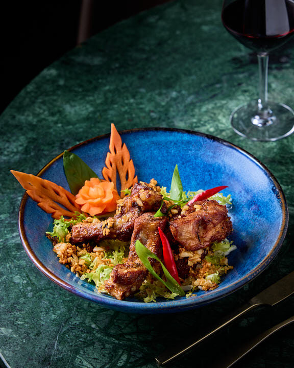 Travers de porc sautés à l’ail et au poivre servis au restaurant Suanthai